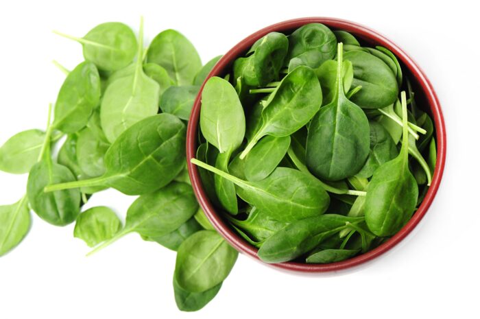 Bowl of spinach seen from above illustrates blog "What Produce Contains Iron?"