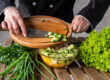 Chef preparing Mediterranean salad with Persian cucumbers