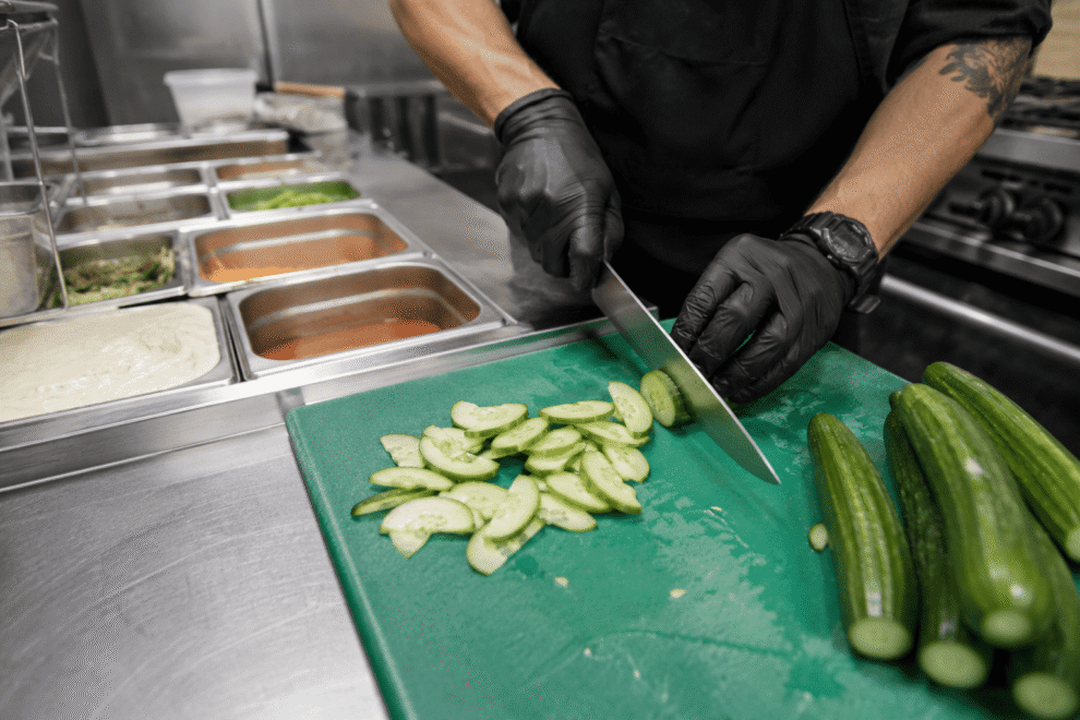 Fresh Persian cucumbers prepared in a foodservice kitchen for efficient use
