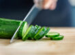 Chef preparing Persian cucumbers for a fresh salad program