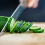Chef preparing Persian cucumbers for a fresh salad program